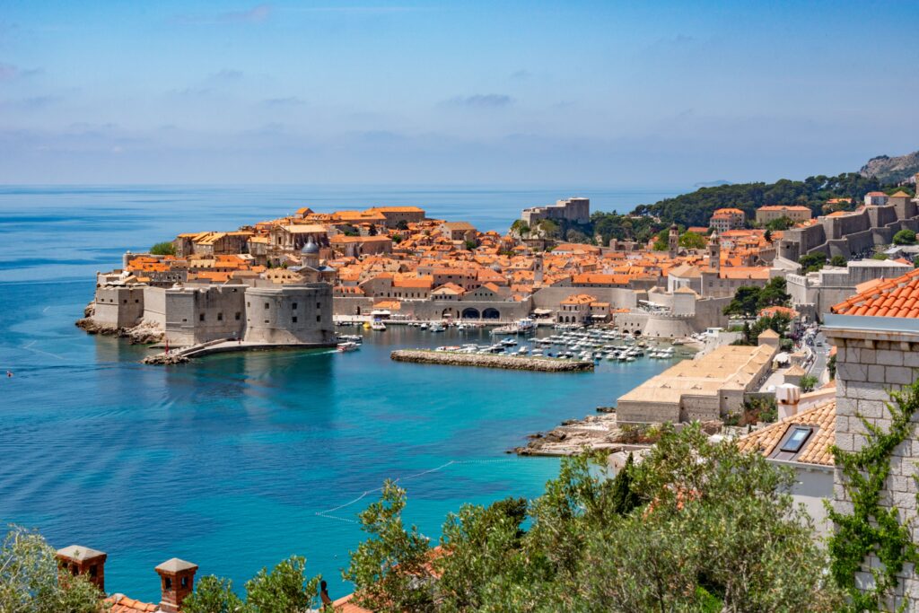 Scenic view of Dubrovnik's historic old town with iconic city walls and Adriatic coastline.